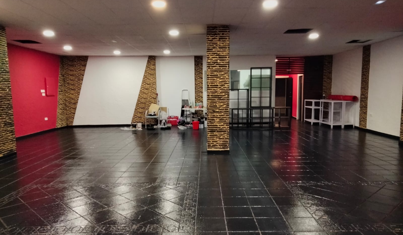 Cannabis club event space interior with tiled floor and feature columns
