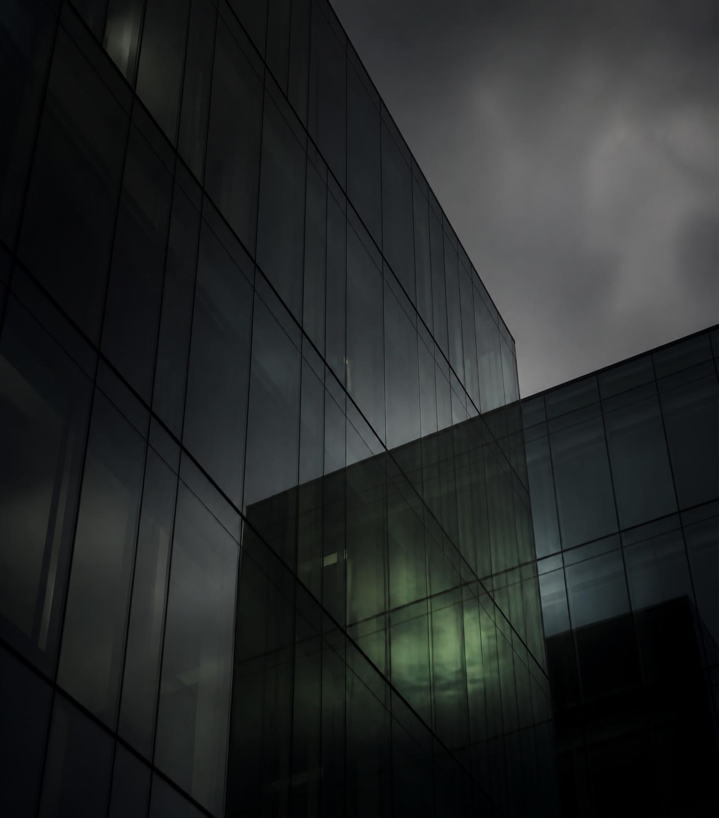 Dark glass office facade at dusk