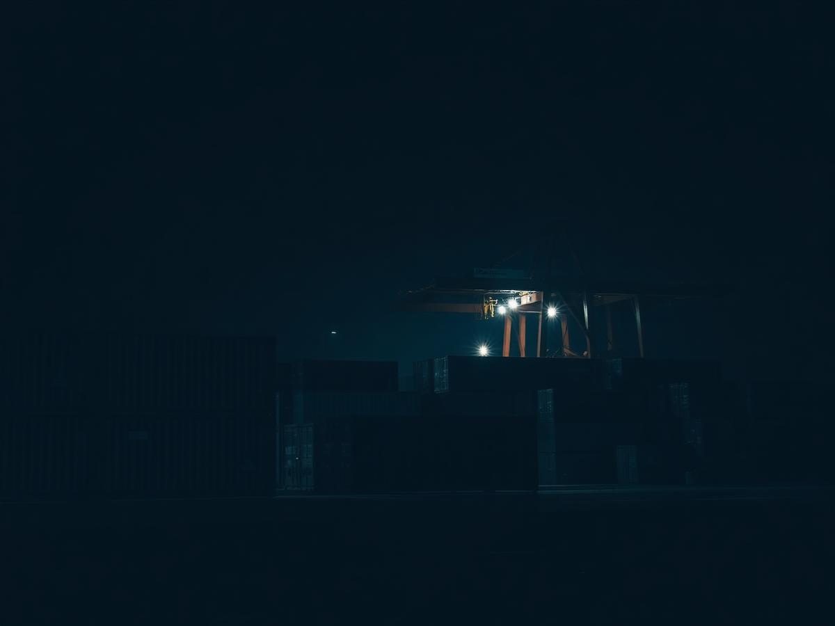 Pallets and cases in a distribution warehouse, low light